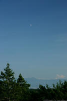 Moon against the Olympic Mountains - photo by Joe Carr