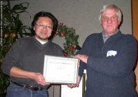 David Lee presenting the certificate to Bill Almond