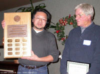 David Lee presenting the plaque to Bill Almond