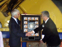 Greg Fahlman accepts a framed print from Kevin Pearson